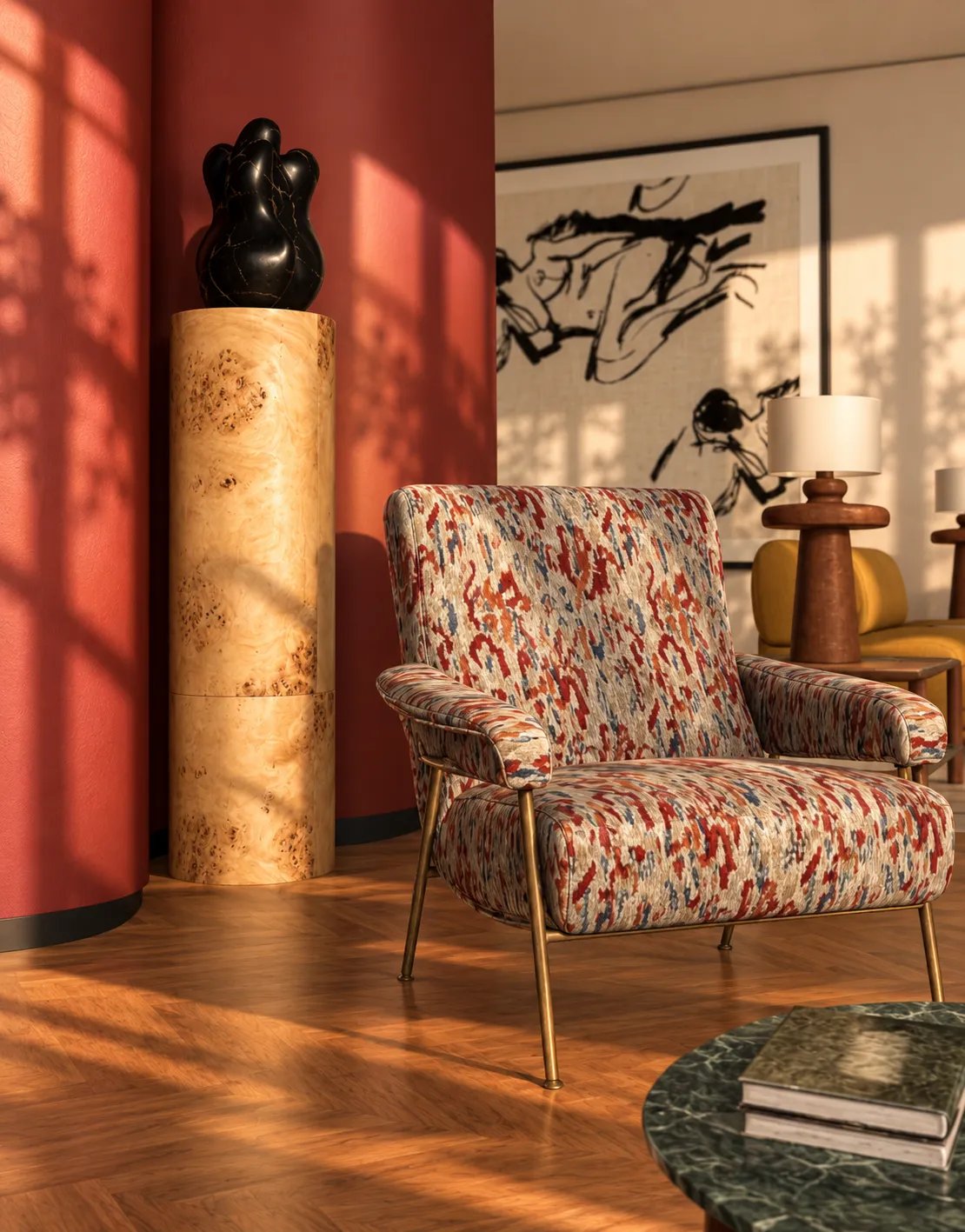 Ikat-patterned armchair beside the burgundy column, with a burl-wood pedestal and black sculpture in golden light
