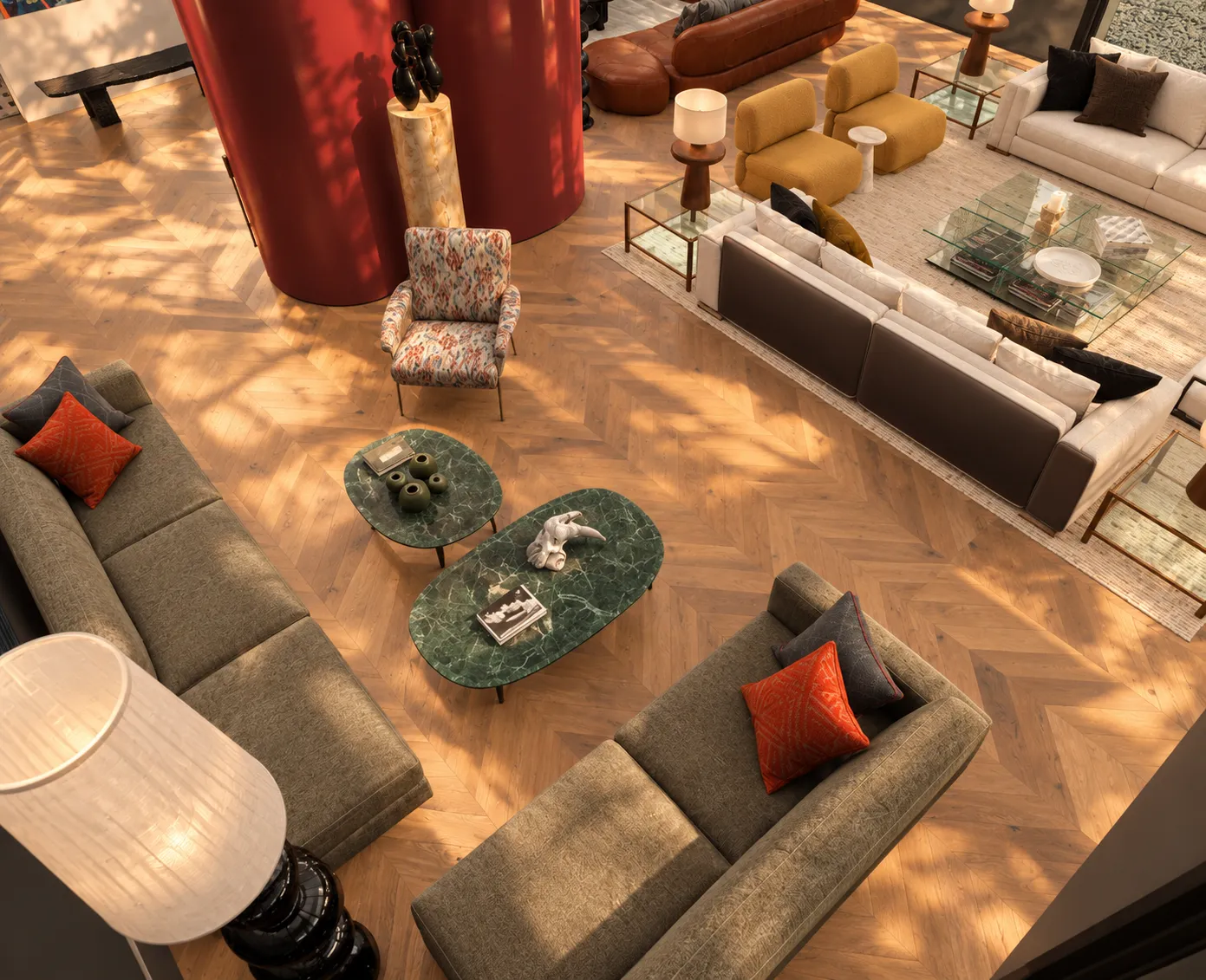 Overhead view of the living area with sage-green sofas, green marble tables and the burgundy column on herringbone oak